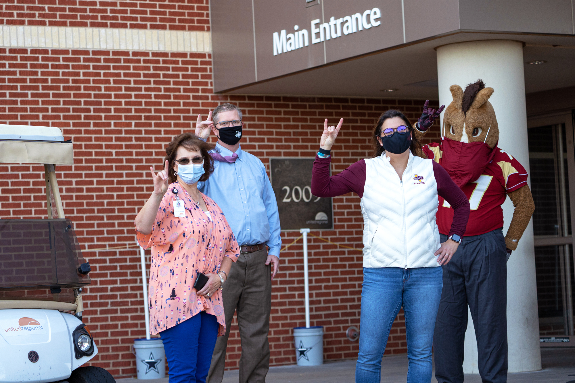  Kim Maddin, left, of United Regional accepted the donation of masks from Dr. David Carlston, Reagan Foster, and Maverick. 
