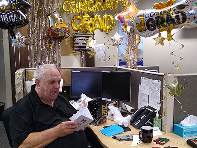 Billy Wade Parsons sits among his party decorations celebrating his graduation at age 78