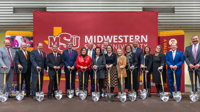 Groundbreaking ceremony photo with shovels in hand, although it's an indoor photo because of the rain and sleet that day 
