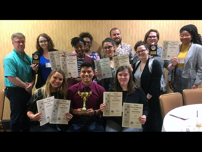 Student group poses with awards