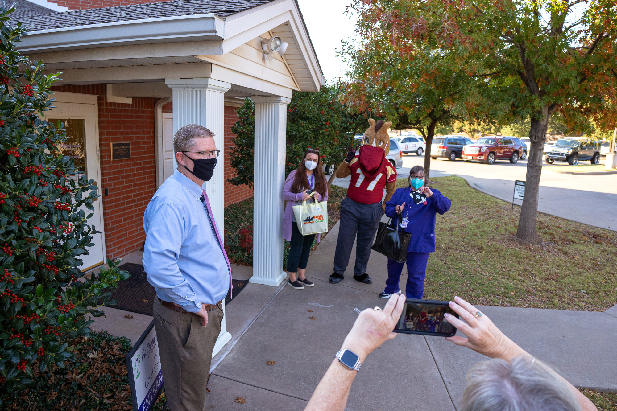 Dr. David Carlson and Maverick present Courtney Galloway and Val Thompson with masks as a show of appreciation to the community’s frontline health-care employees.