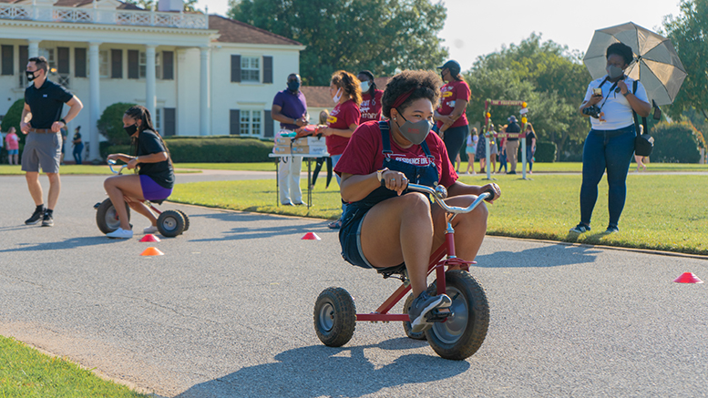 MSU Texas student Jaye Surles participates in the tricycle races while practicing the proper safety measures.