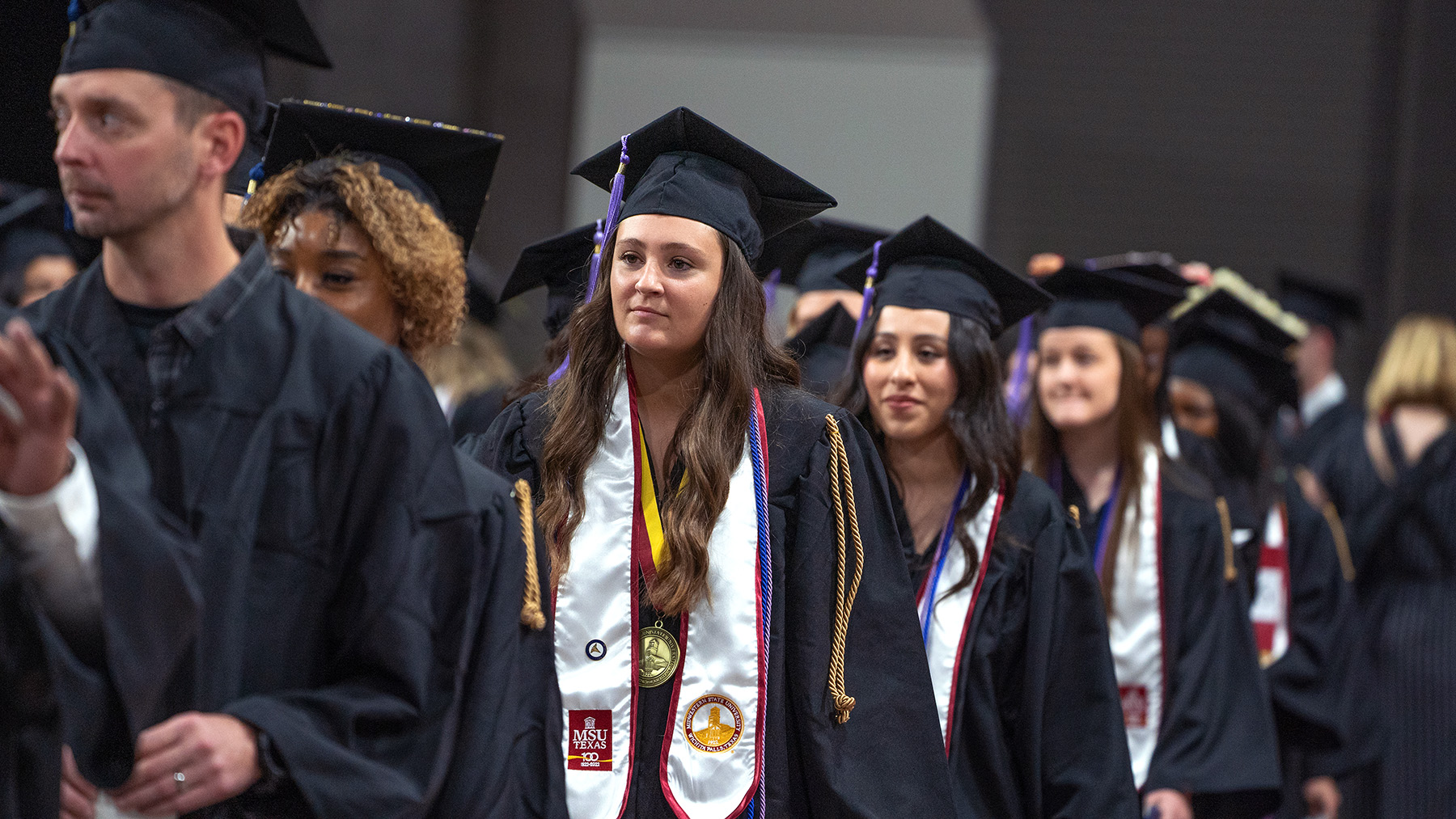 Graduate proudly wears medal at Spring 2022 graduation ceremony