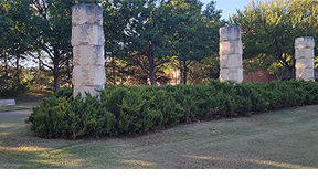 Three pillars on lawn near Bolin Hall