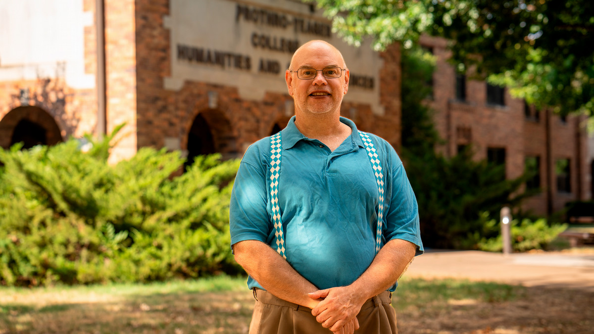 John Ashbrook stands outside of Prothro-Yeager College