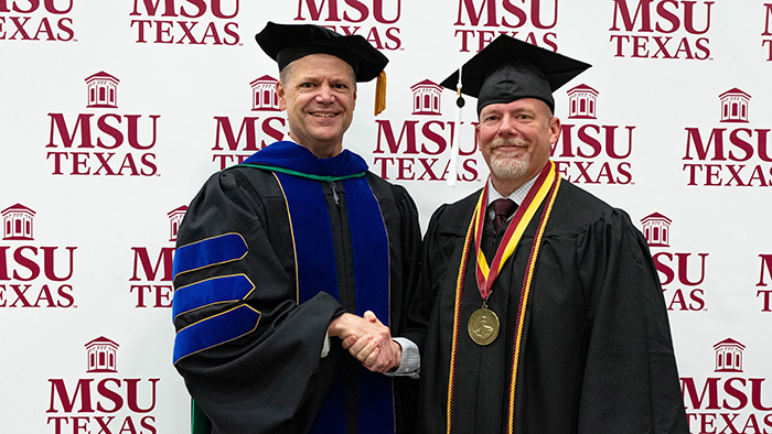 Christian Hadash with Dr. Keith Lamb after receiving medal