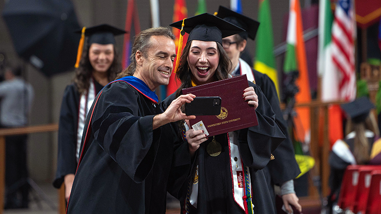 Dr. Steve Garrison smiles as he congratulates a graduate