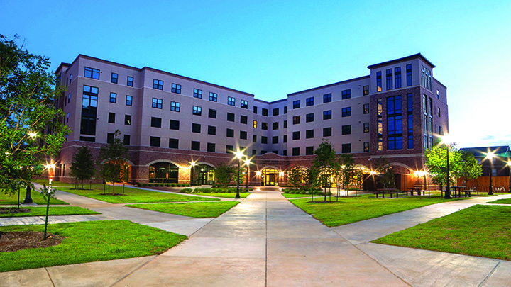  Legacy Hall couryard photo in evening with view of yard and both wings of  building