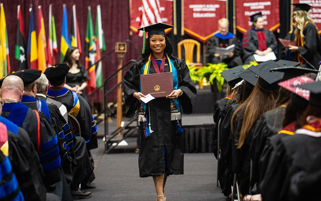 Madison Ingraham receivers her diploma in the Spring 2024 Graduation at D.L. Ligon Coliseum