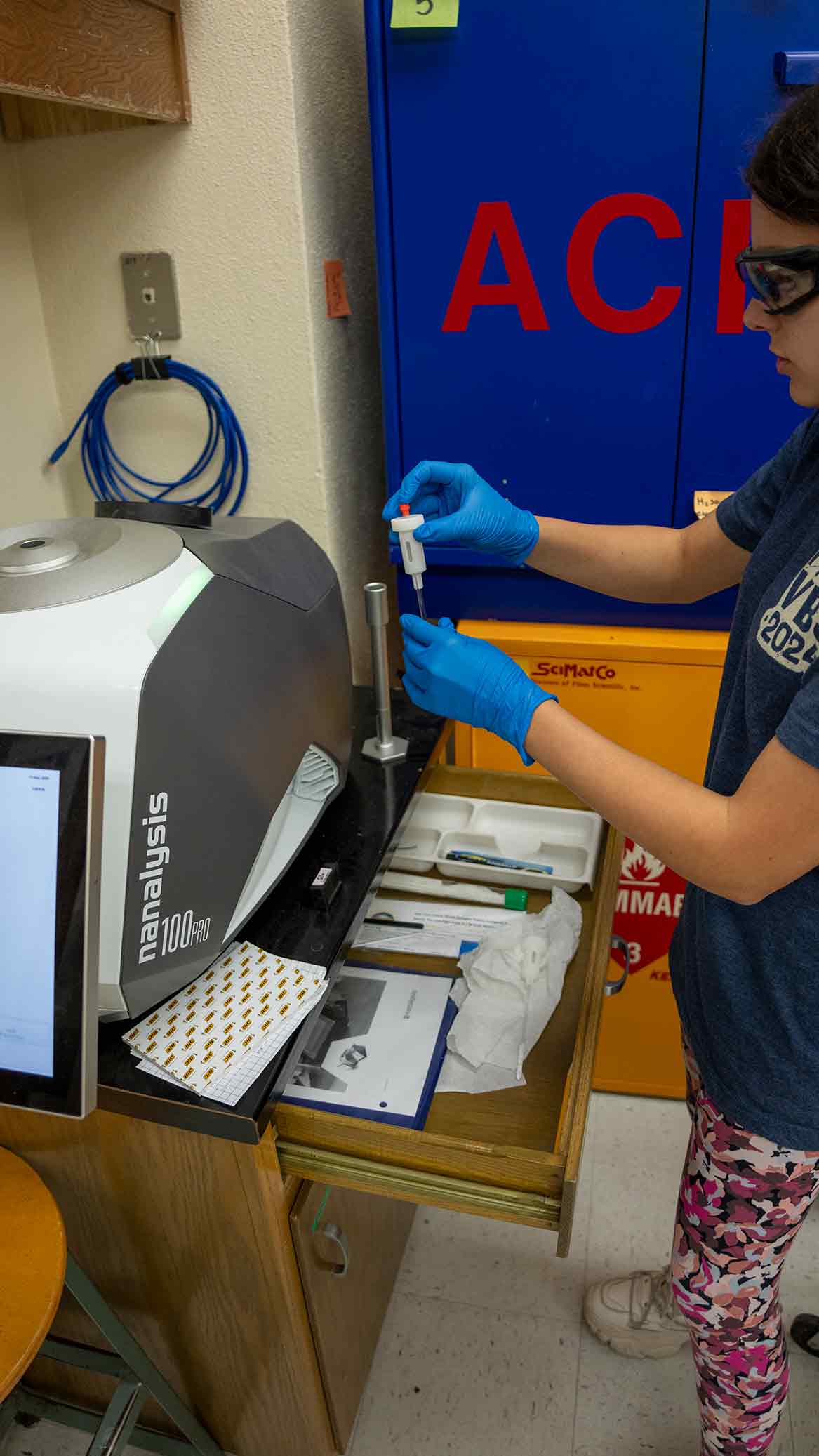 Organic Chemistry research student and teaching assistant Glenna Linthicum prepares a sample for analysis in the NMR spectrometer.