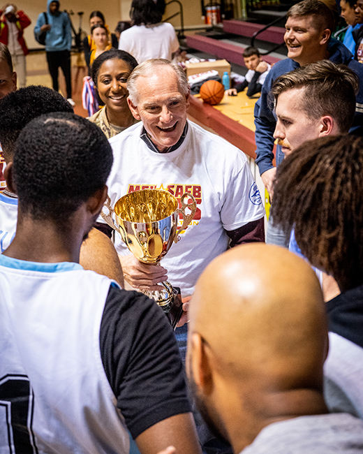 MSU Texas Athletic Director Kyle Williams hands a trophy to the basketball team from Sheppard Air Force Base