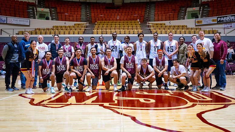 The teams from SAFB and MSU Texas smile for a group photo at D.L. Ligon Coliseum