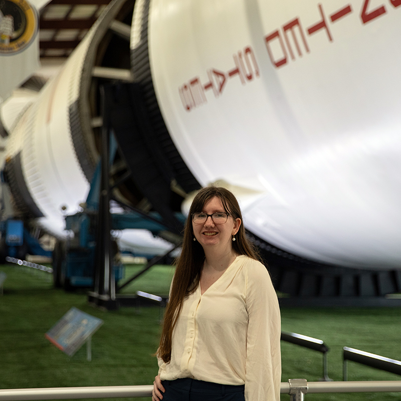 Allyson Warren stands in front of plane in Houston
