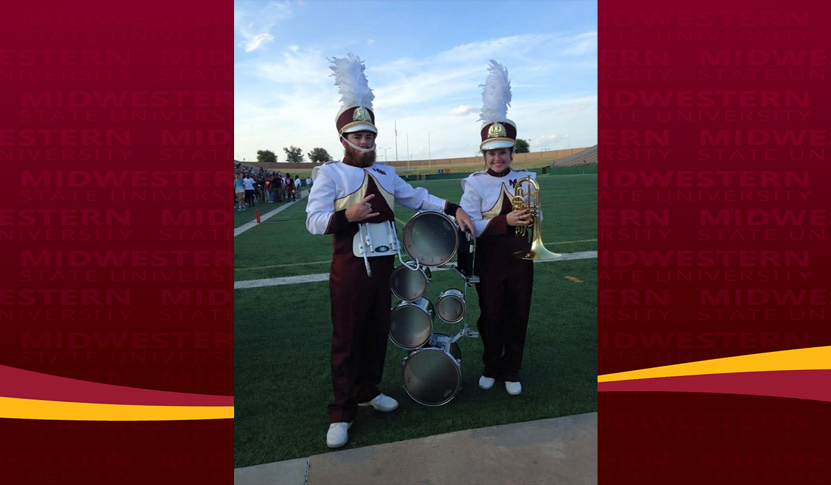 Branson Spencer on field with the band in his time at MSU Texas