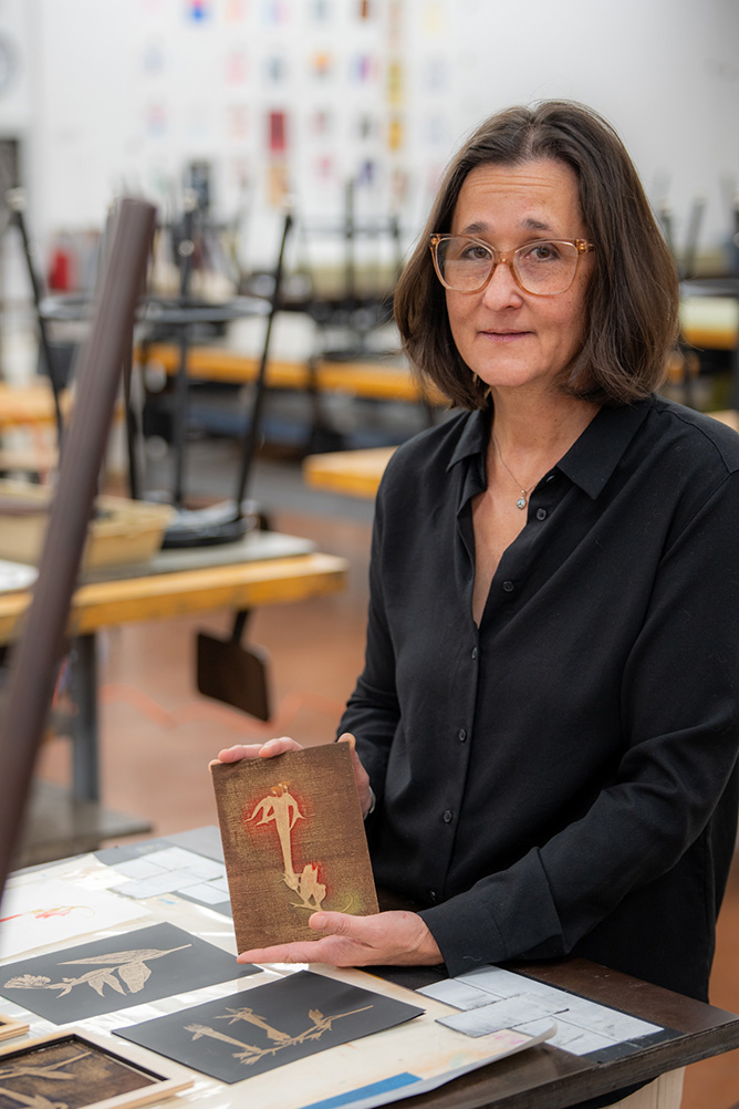 Cat Prosse stands above her art