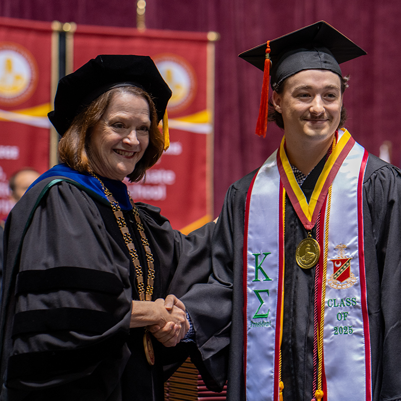 Colby Brasher receives President's Medal of Excellence from Dr. Haynie
