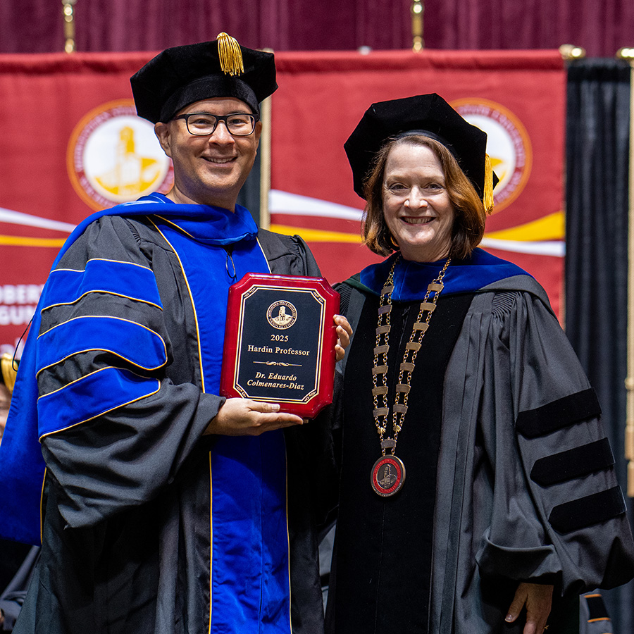 President Stacia Haynie presents Eduardo Colmenares with Hardin Professor award