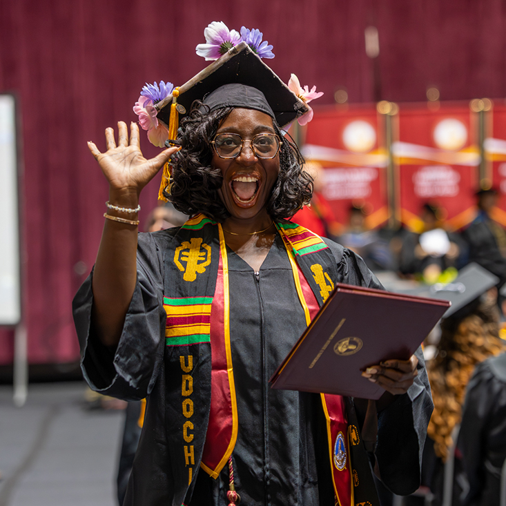 Fall 2025 Graduation as graduate raises arm in celebration