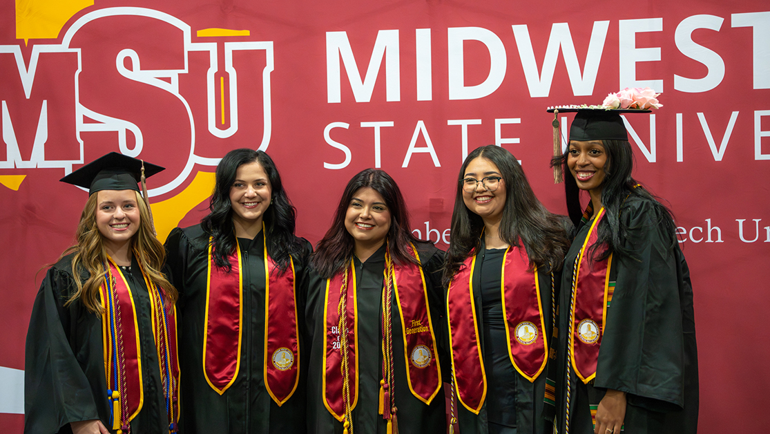 Large group smiles after walking the stage at Fall 2025 MSU Texas graduation