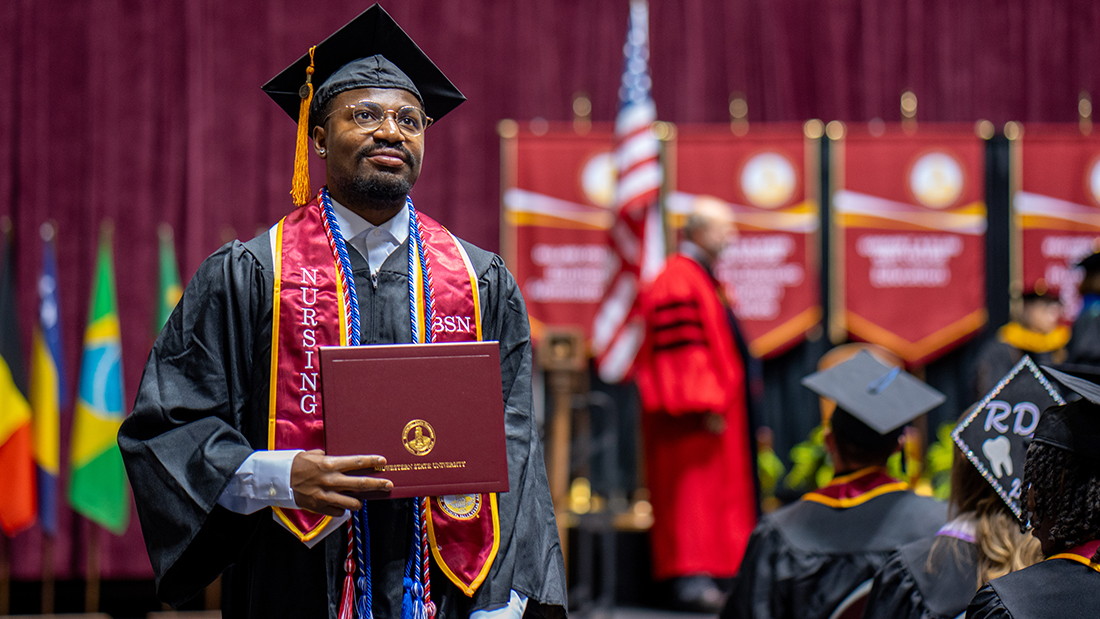 Graduation photo with a young man taking in the moment