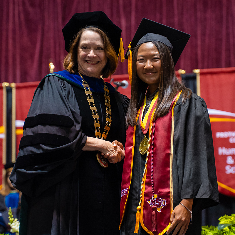 Hannah Yip receives President's Medal for Excellence from Dr. Haynie