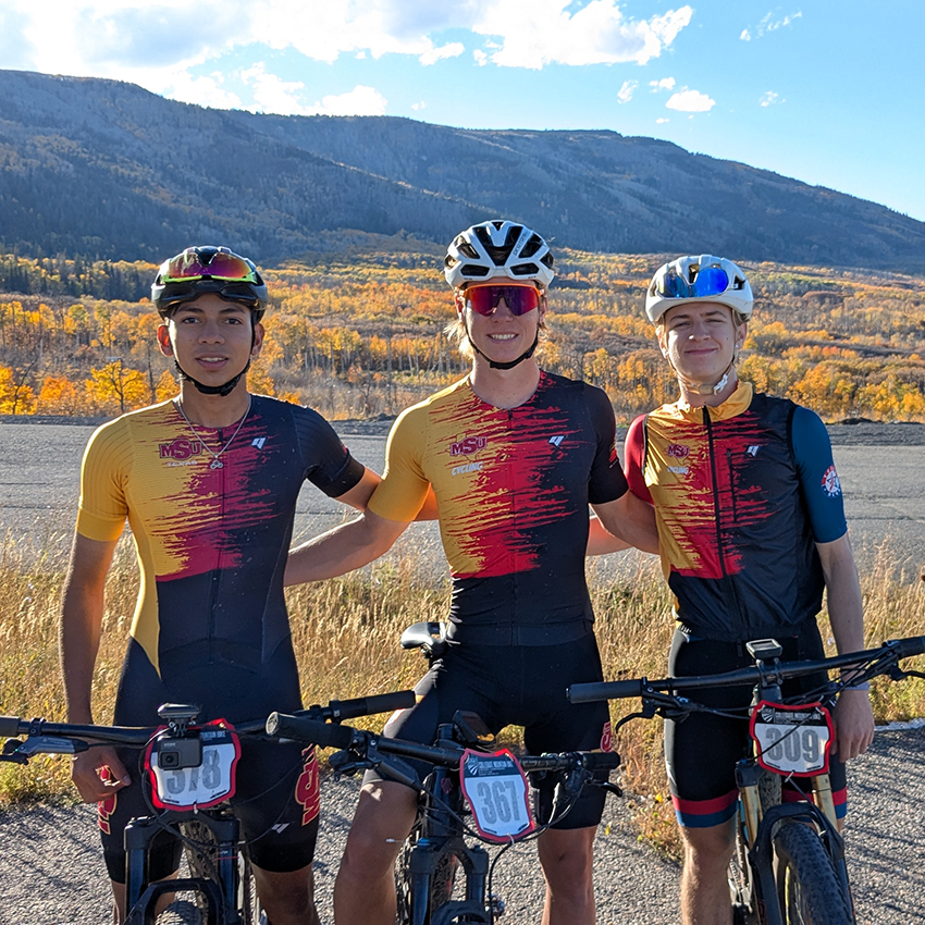 Mauri Maldonado, Blake Keeling, Cole Barrera of MSU Cycling pose for photo with mountains in the background