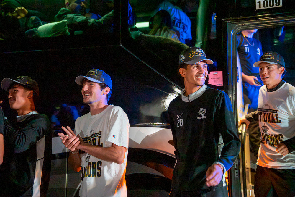 Soccer team excited to get off bus and talk title with the crowd