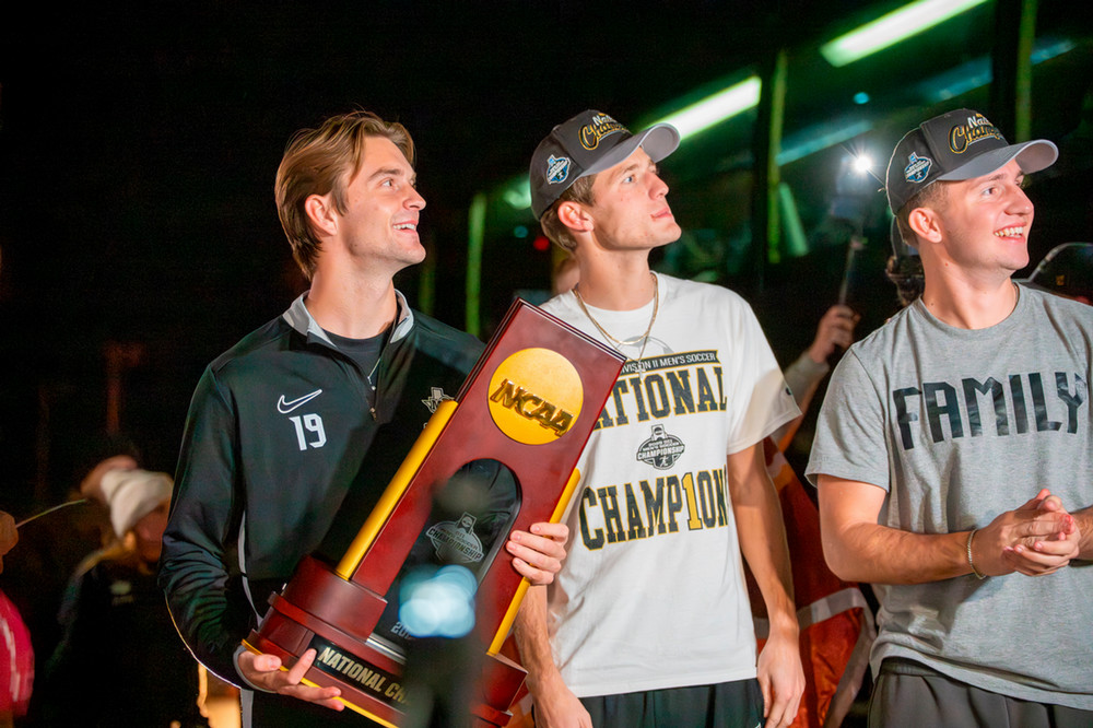 Soccer team members hold up trophy for crowd in Wichita Falls