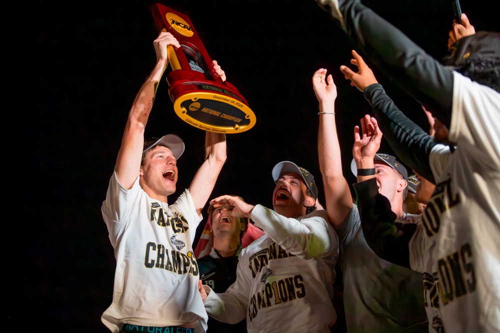 Soccer team members celebrate getting off the bus