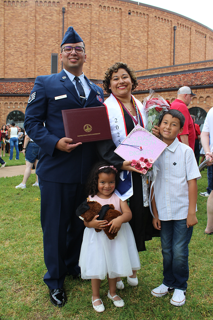 Wendy Romero with her family outside of D.L. Ligon Coliseum on graduation day