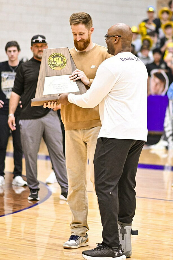 Nick Powell, a former player and coach at Midwestern State, accept a trophy after his Henrietta High School basketball team won a playoff game