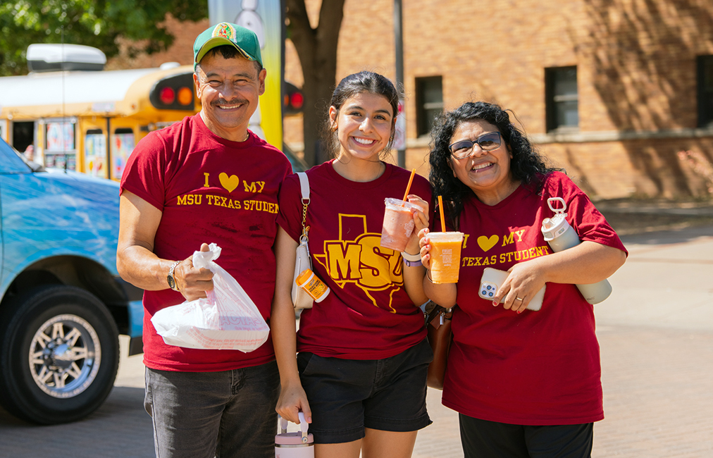 Family enjoys the activities on Family Weekend with their maroon MSU Texas shirts
