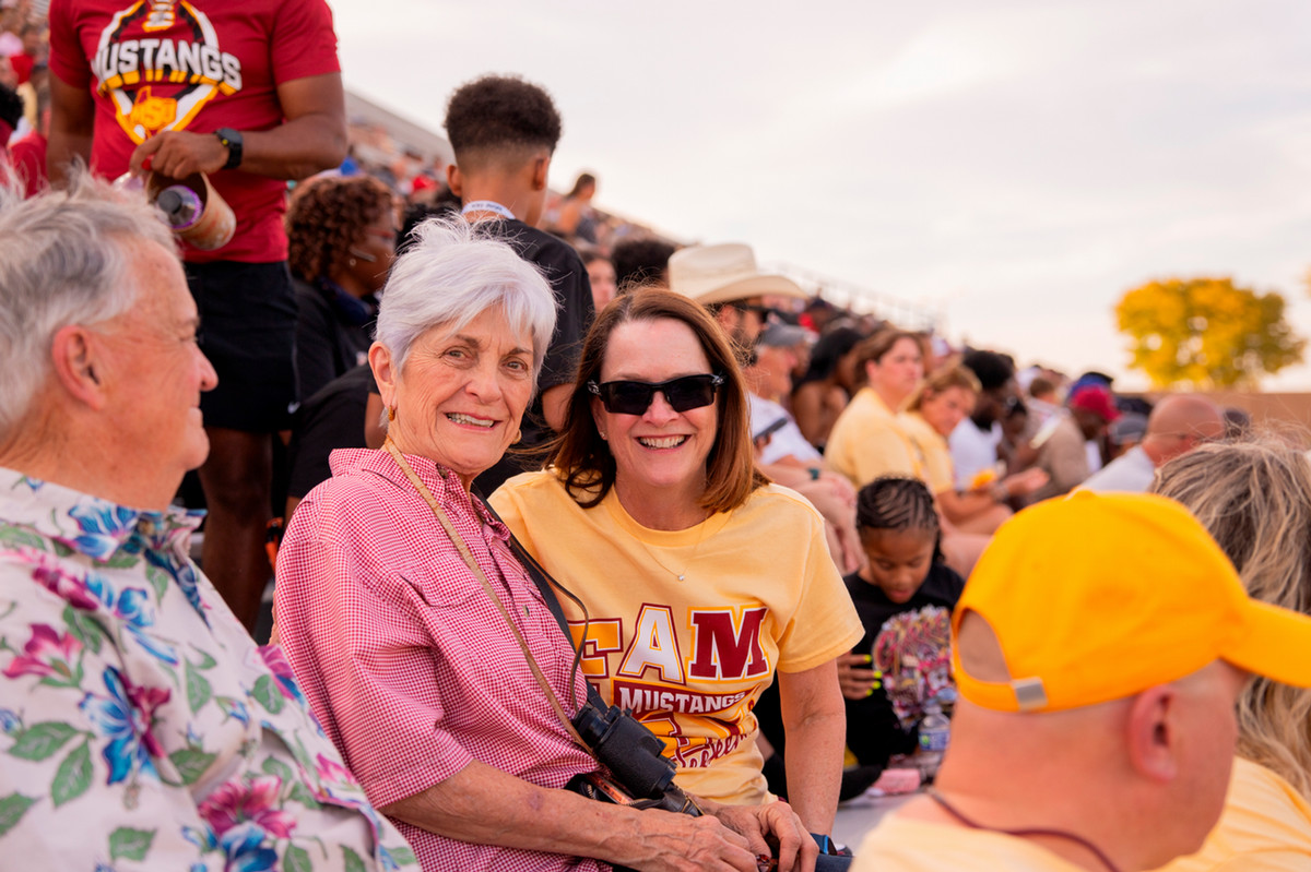 MSU Texas President Stacia Haynie with fans at the football game
