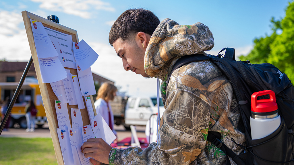 An MSU Texas donor signs the board showing what he loves about MSU Texas