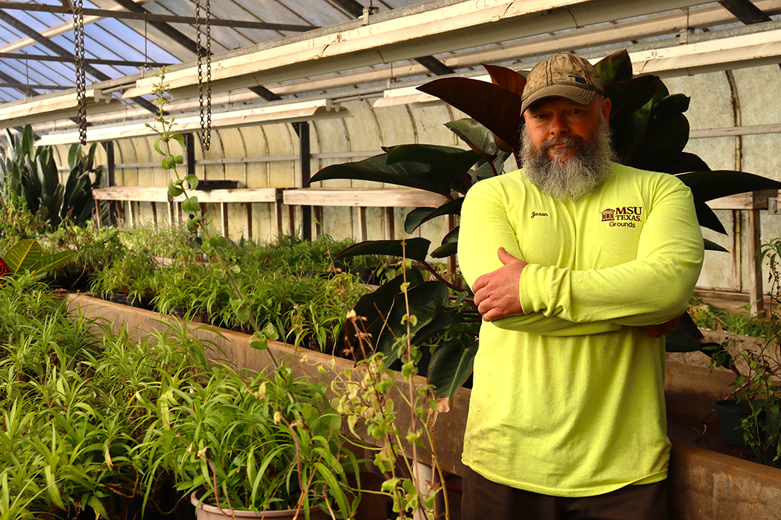 Jason Cooper, longtime grounds maintenance superintendent at MSU Texas, stands inside the Arthur F. Beyer Greenhouse. 