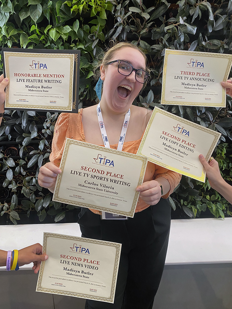 Madisyn Butler with all her honors beside her at Texas Intercollegiate Press Association annual contest