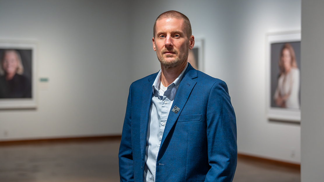 WFMA Director and Curator Matthew Bailey stands before an exhibit at the WFMA