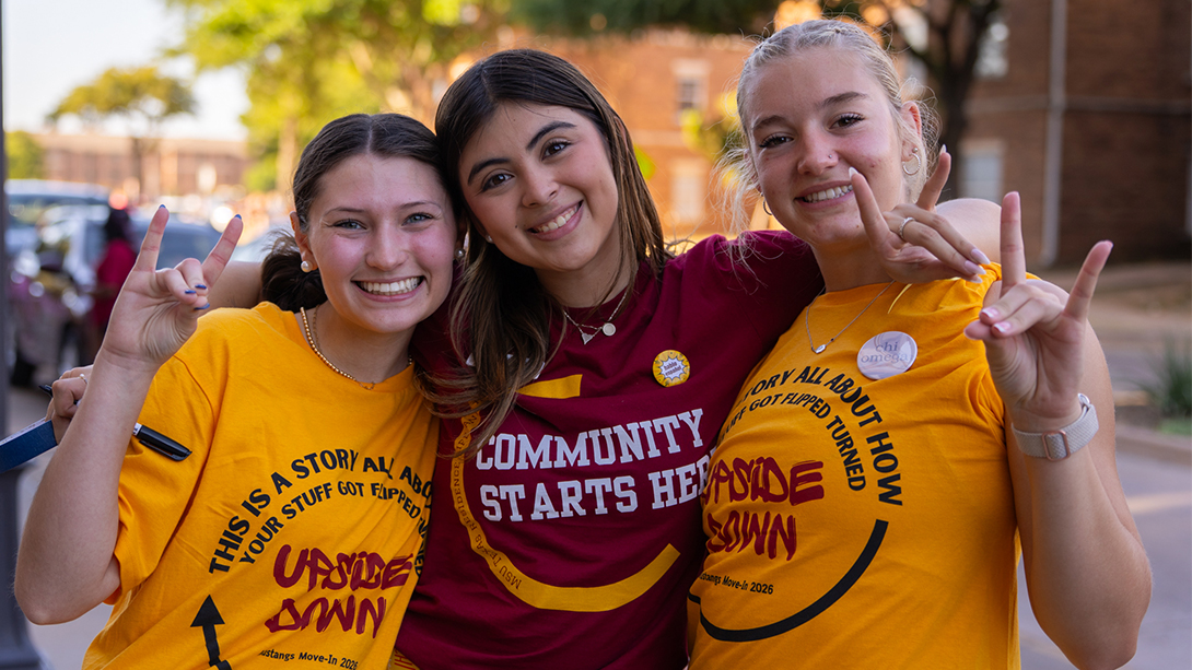 Three young volunteers smiling on Move-In Day