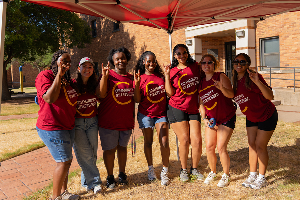 Group of volunteers for Move-In Day pose under the tent