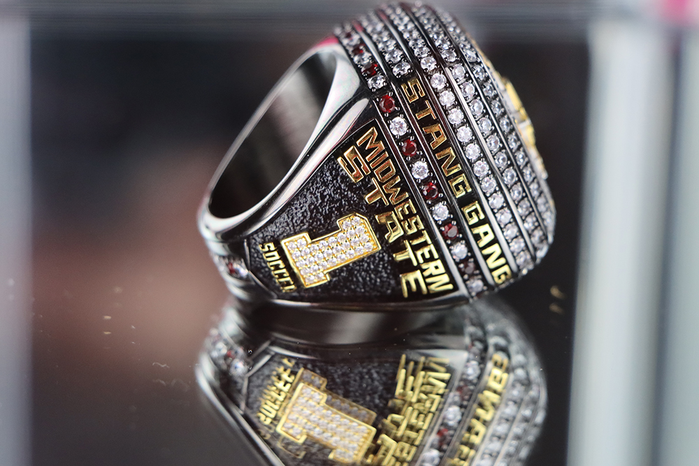 Championship ring displaying STANG GANG Midwestern State Soccer with a 1