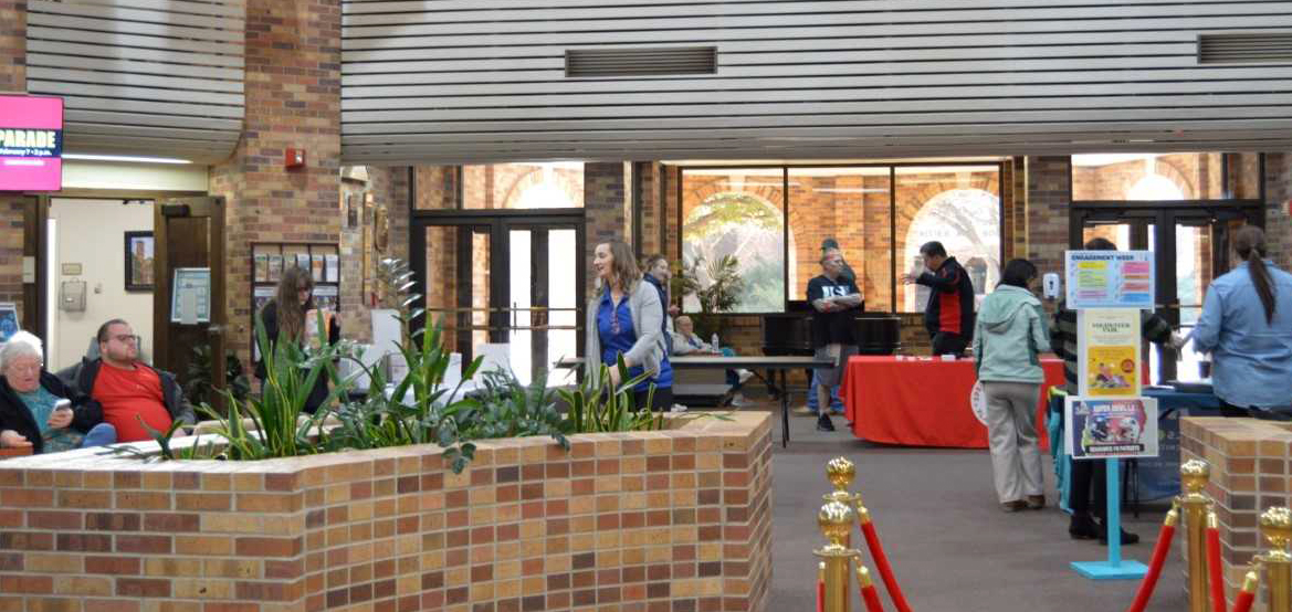 Volunteer event at the Clark Student Center atrium shows several people getting information or relaxing