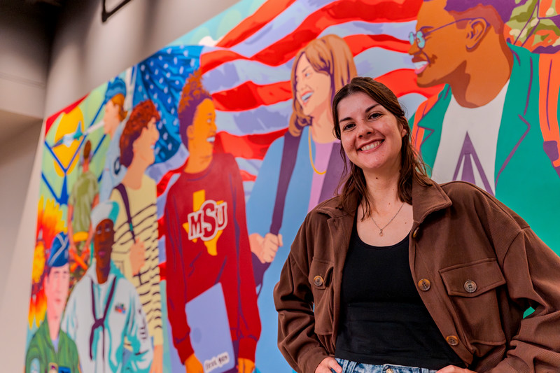 Selena Mize with Bridging the Gap mural