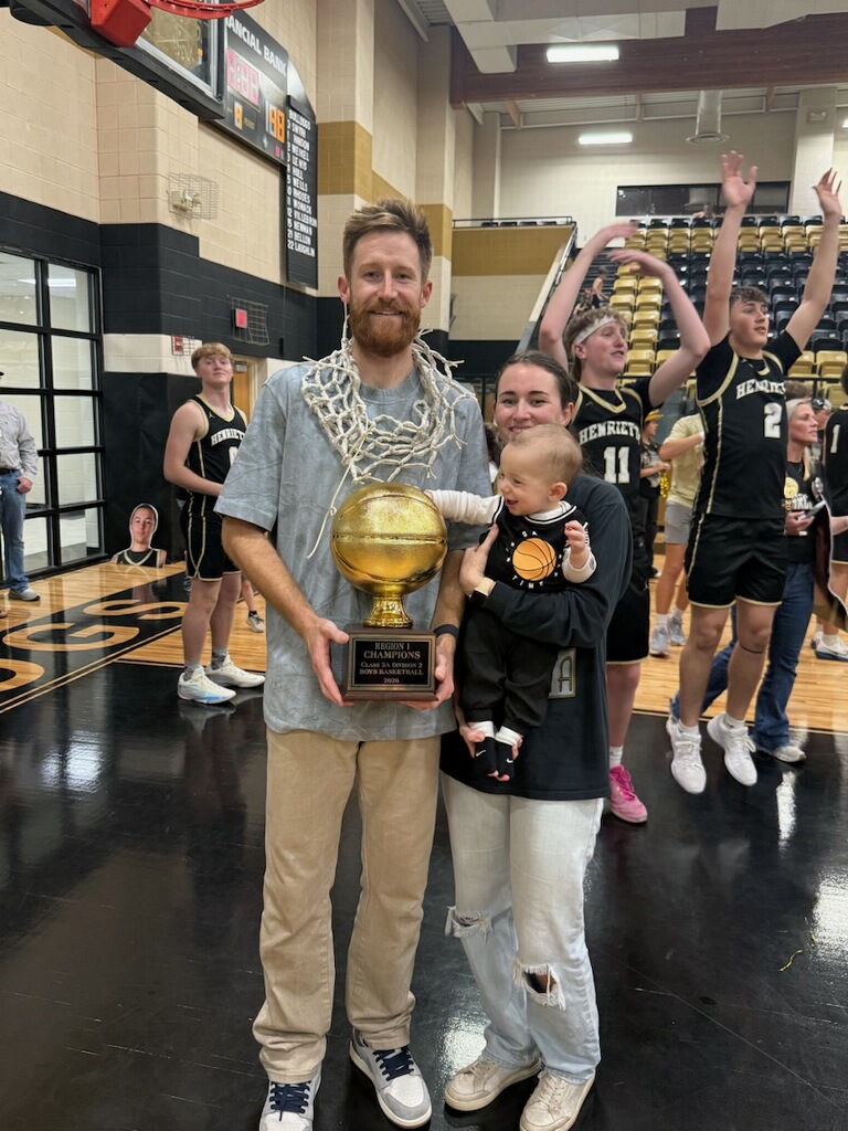 Nick Powell with his wife Anni after winning a high school basketball game at Henrietta High School