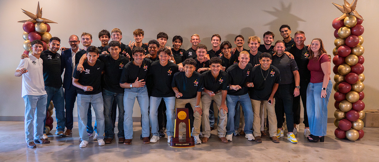Group photo of Mustangs soccer players, coaches, and support staff
