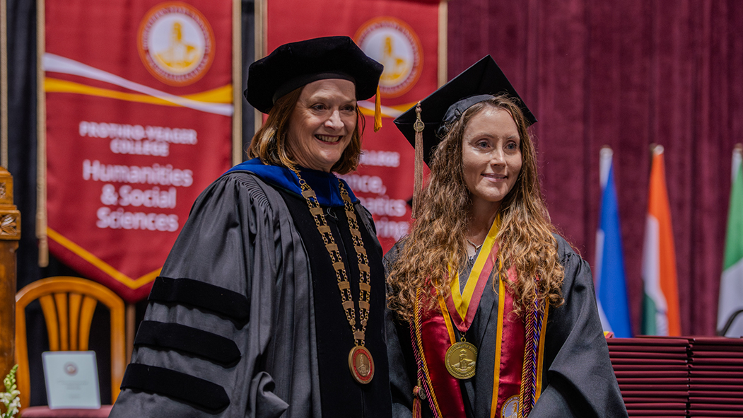 A graduate poses with Dr. Haynie at Spring 2026 Commencement