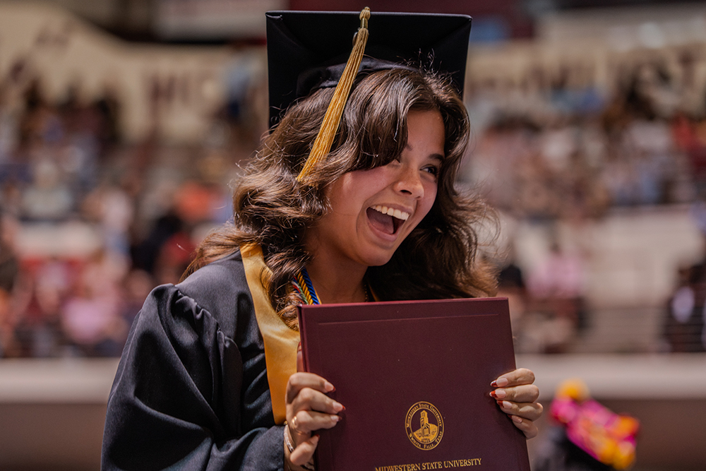Graduate emotional about receiving diploma