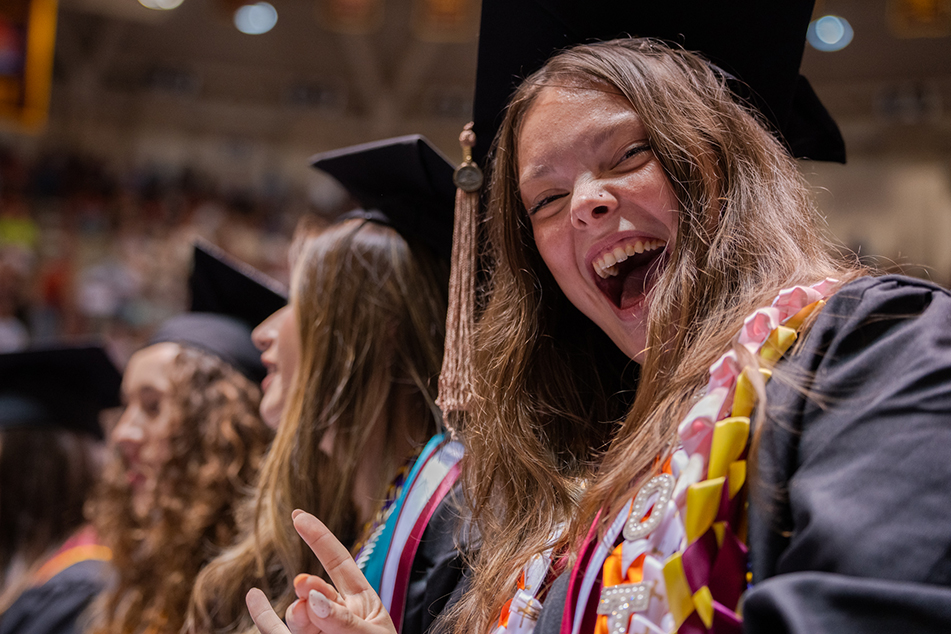 Graduate enjoys a laugh at the Commencement ceremony