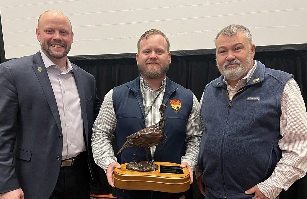 Marcus Thibodeau (center of picture) receives his award